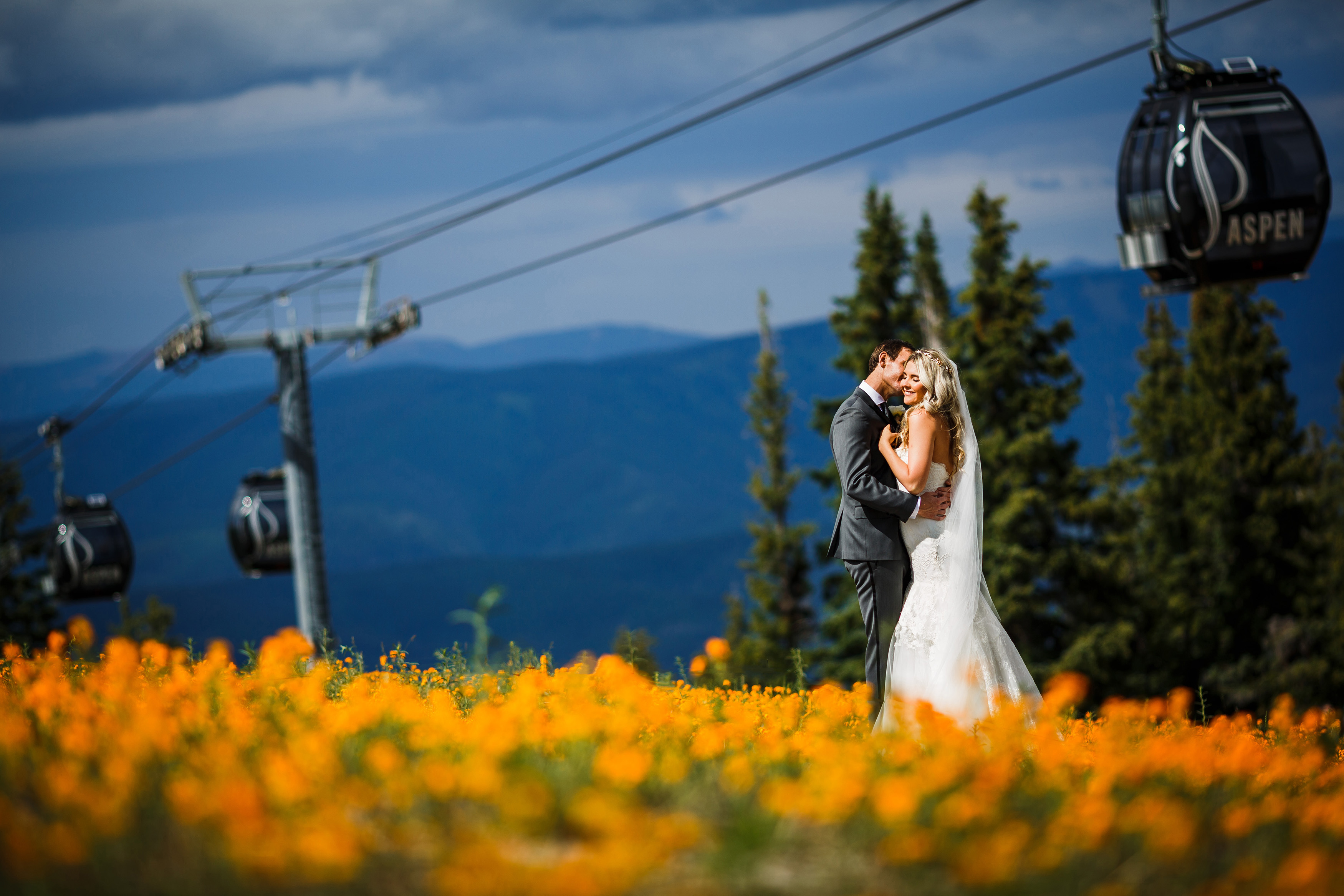 Bride and Groom in field of Wildflowers at Aspen Wedding Deck in Aspen, CO