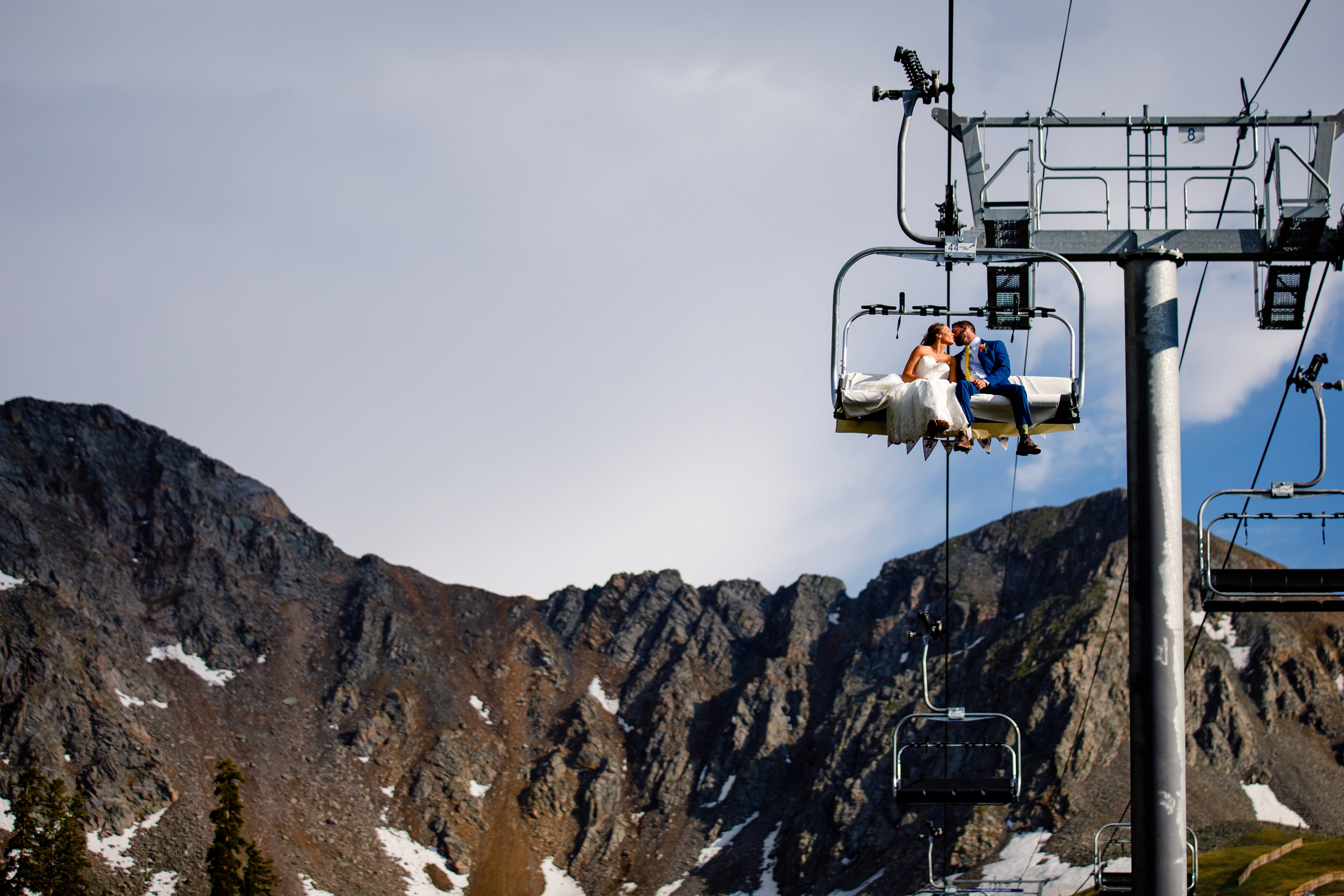 Bride & groom ride the chairlift down at Arapahoe Basin Wedding in Keystone, CO