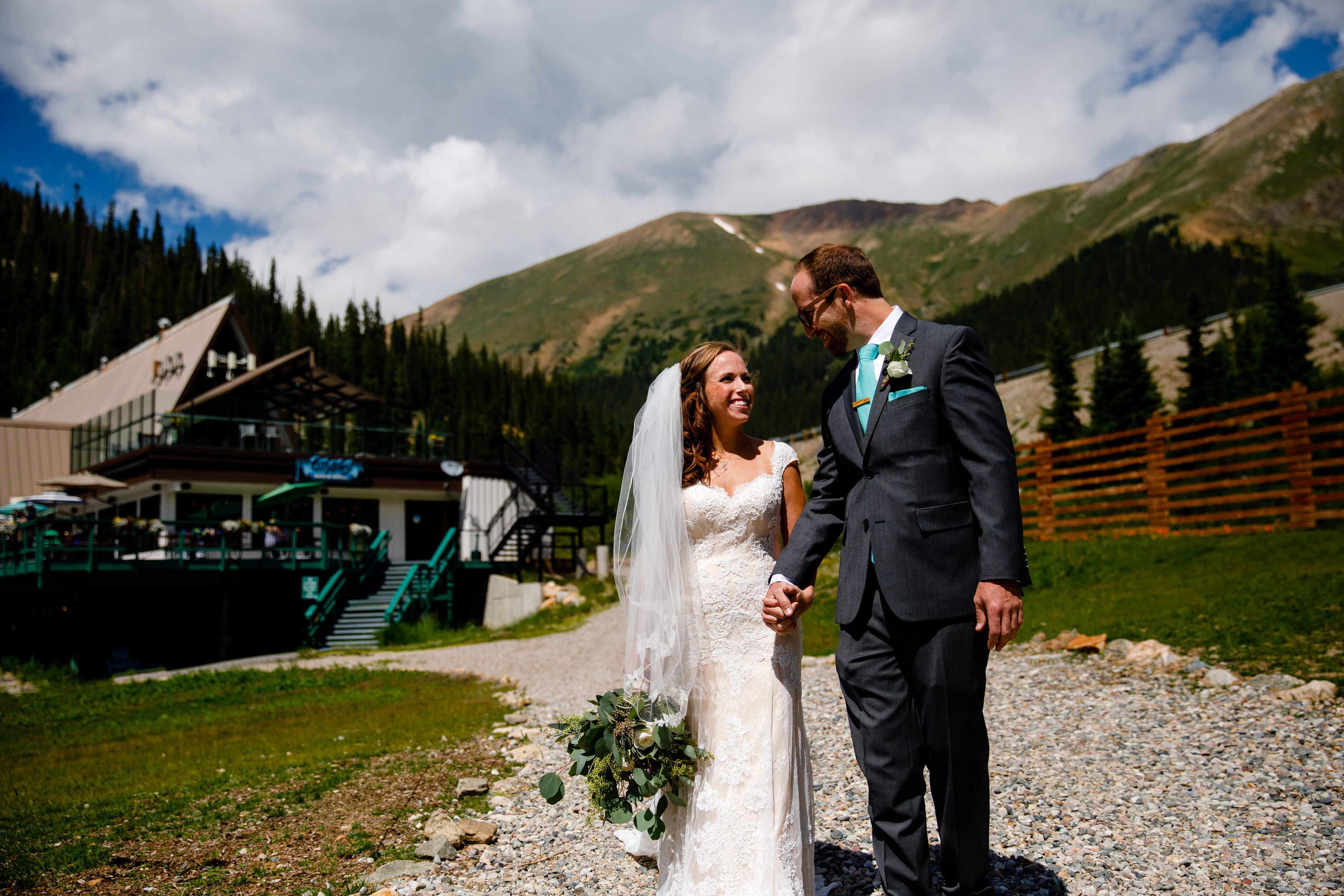 Married couple walking the ski runs at Arapahoe Basin before their wedding.