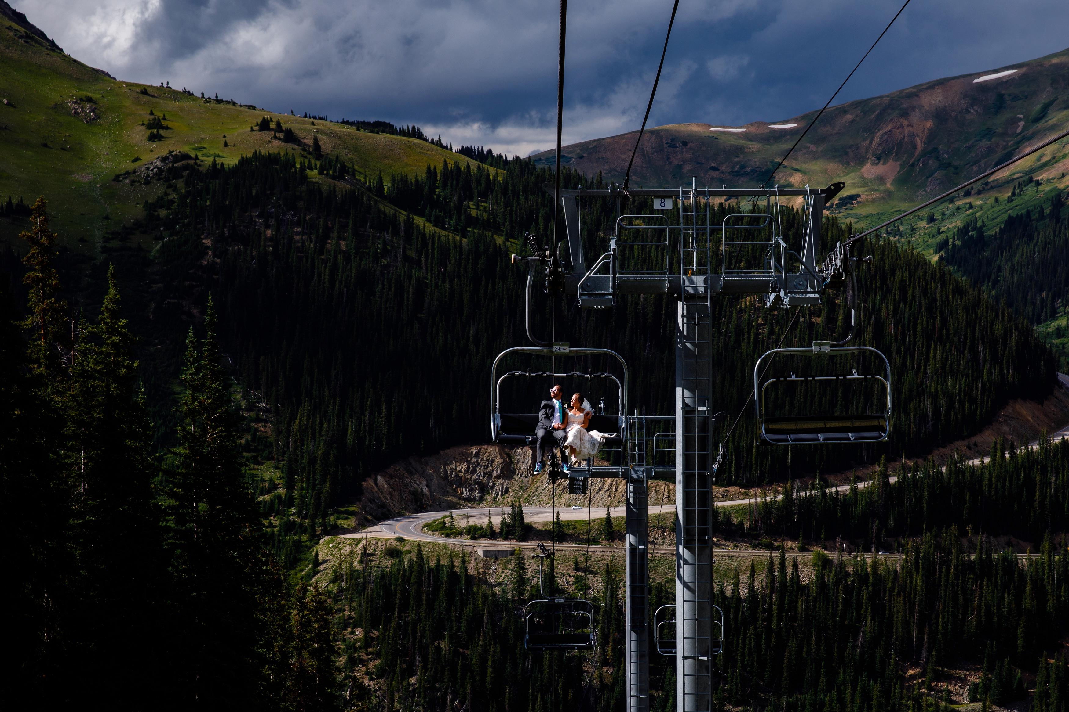Married couple on the chairlift just after their wedding at Arapahoe Basin.