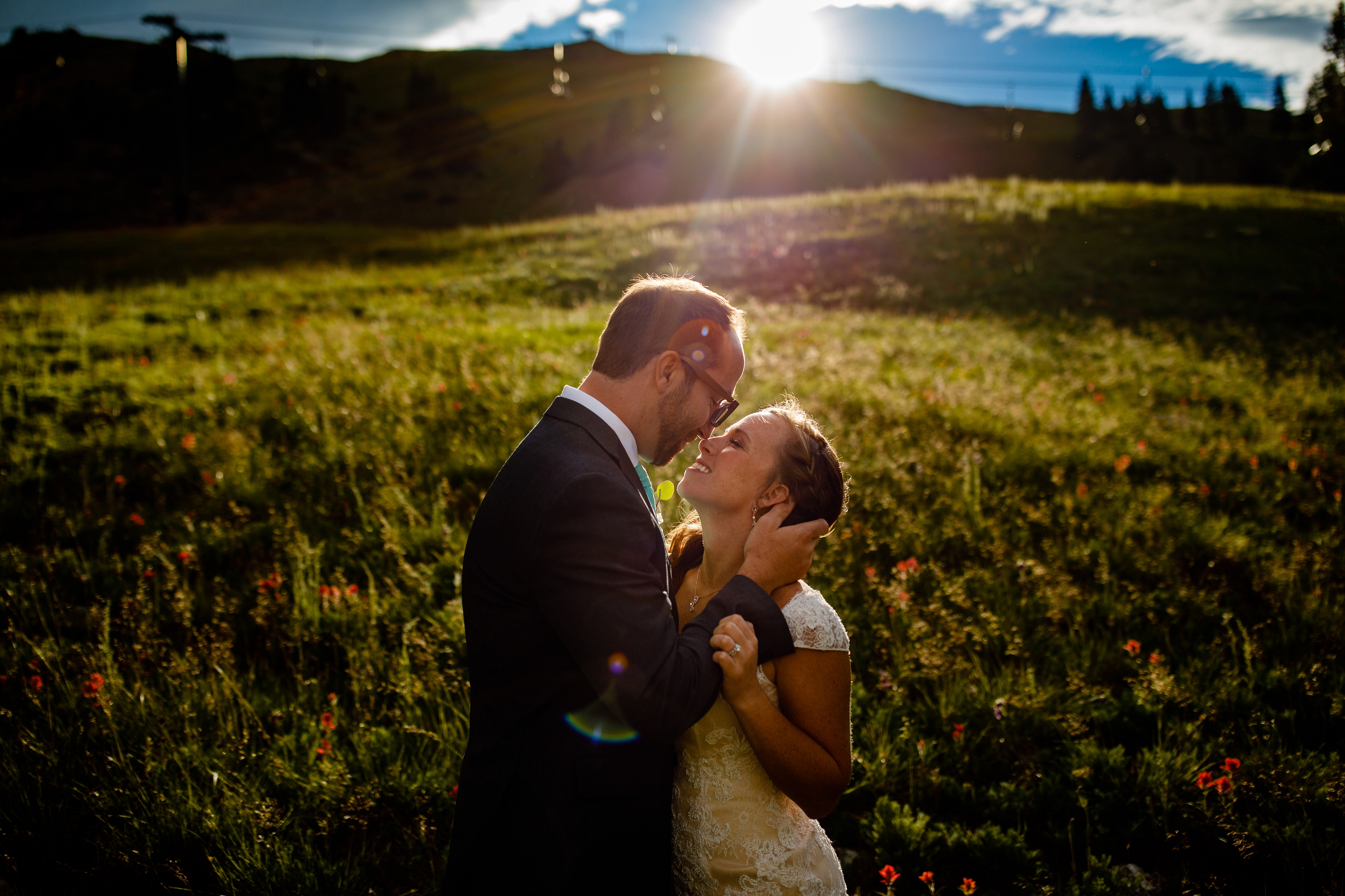 Sun drenched portrait of bride & groom after their wedding ceremony.