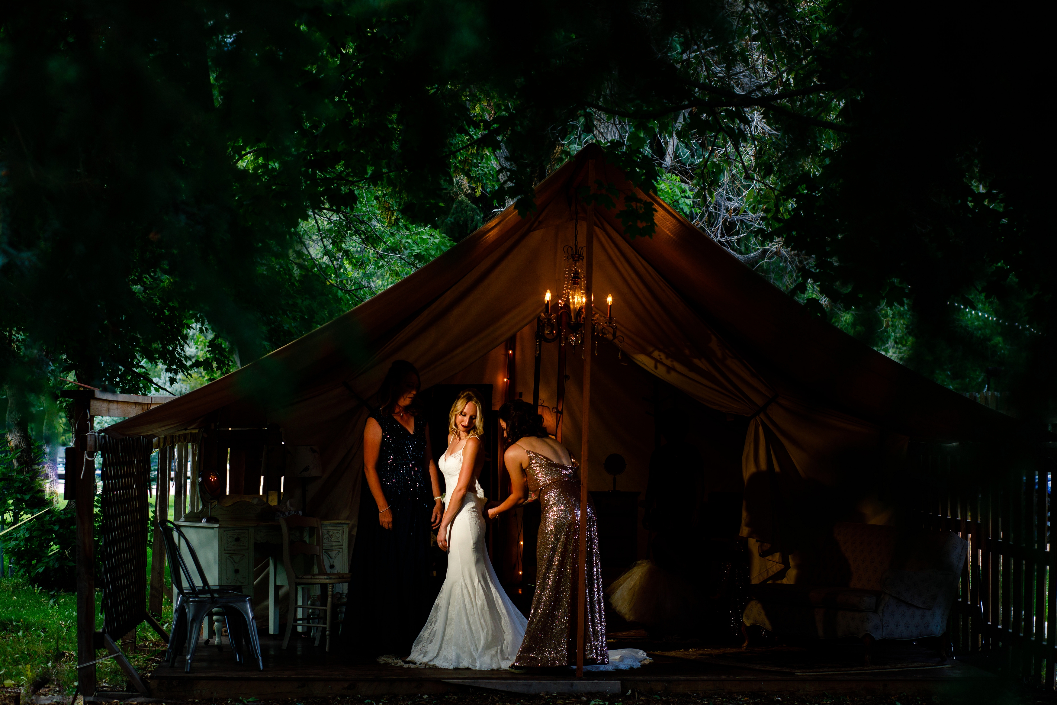 Bride getting ready in the tent at the River Bend venue in Lyons, CO