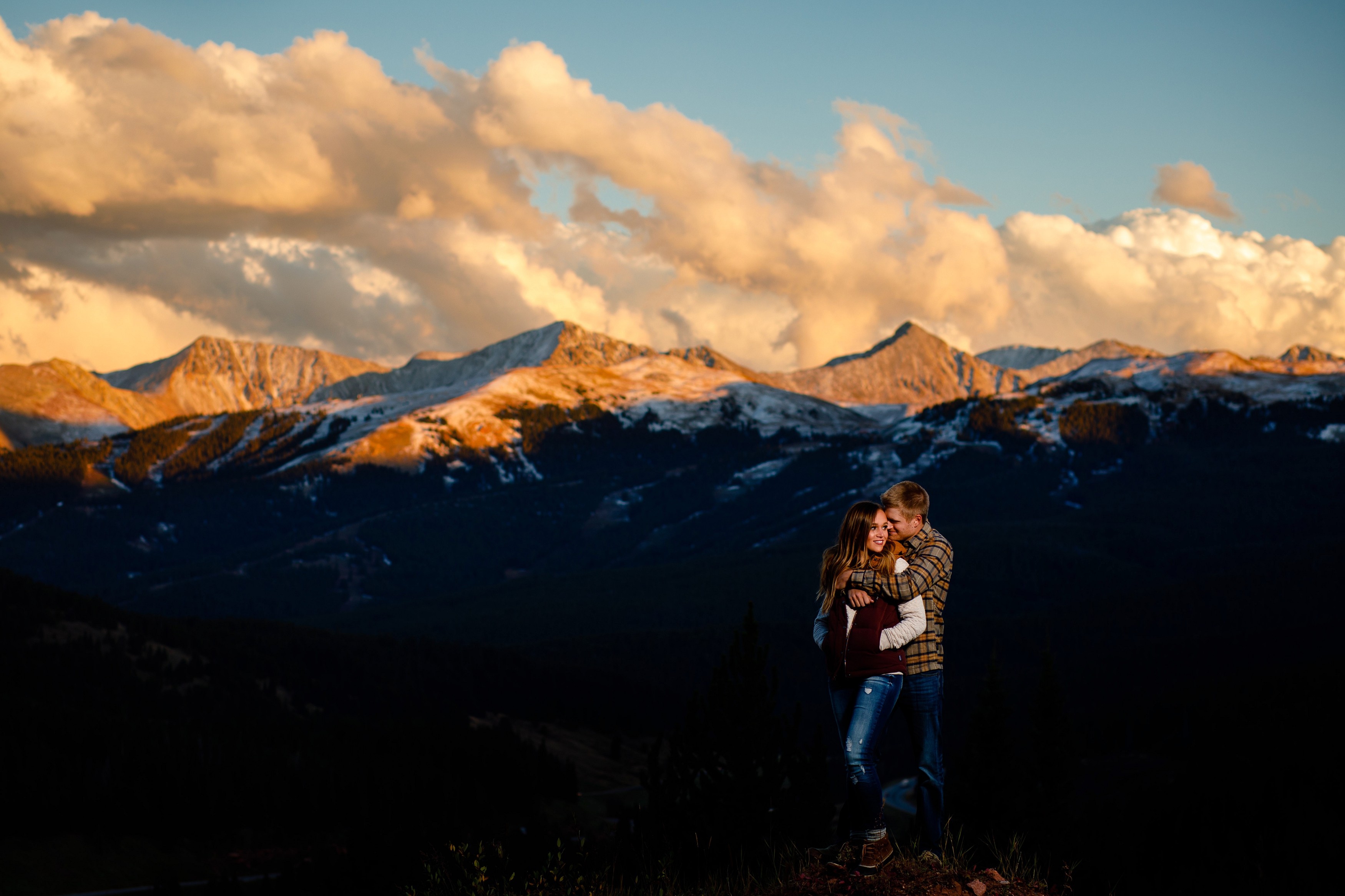 On top of Shrine Pass with Copper Mountain in the background during their Colorado Engagement Photo Session.