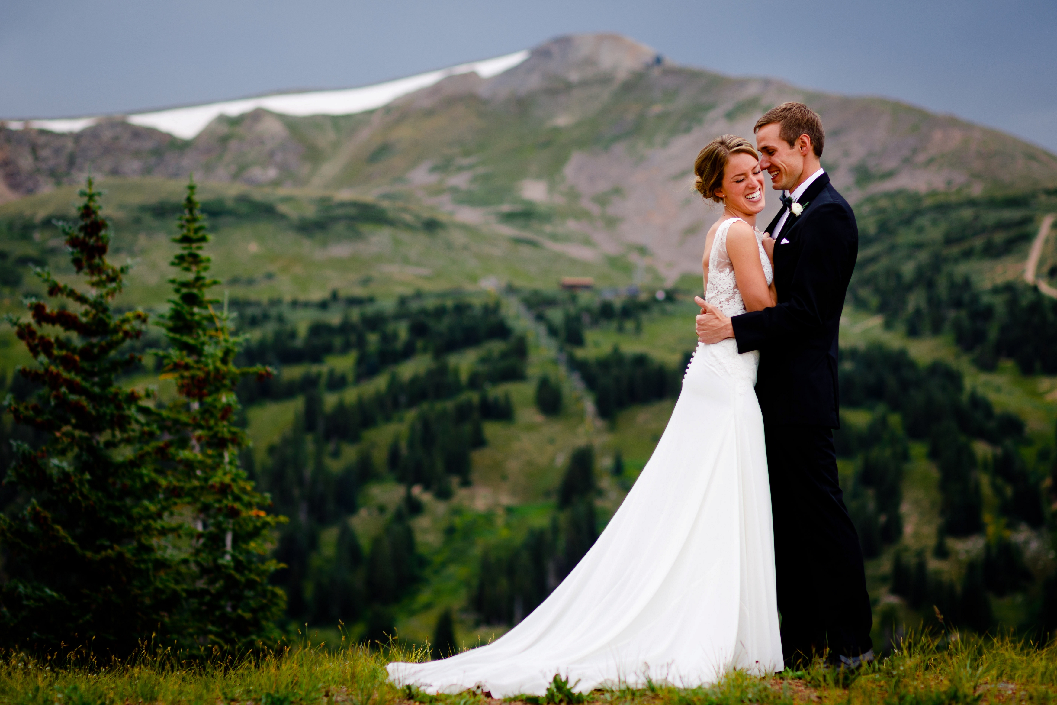 Bride & groom pose for a portrait in front of Peak 9 in Breckenridge.