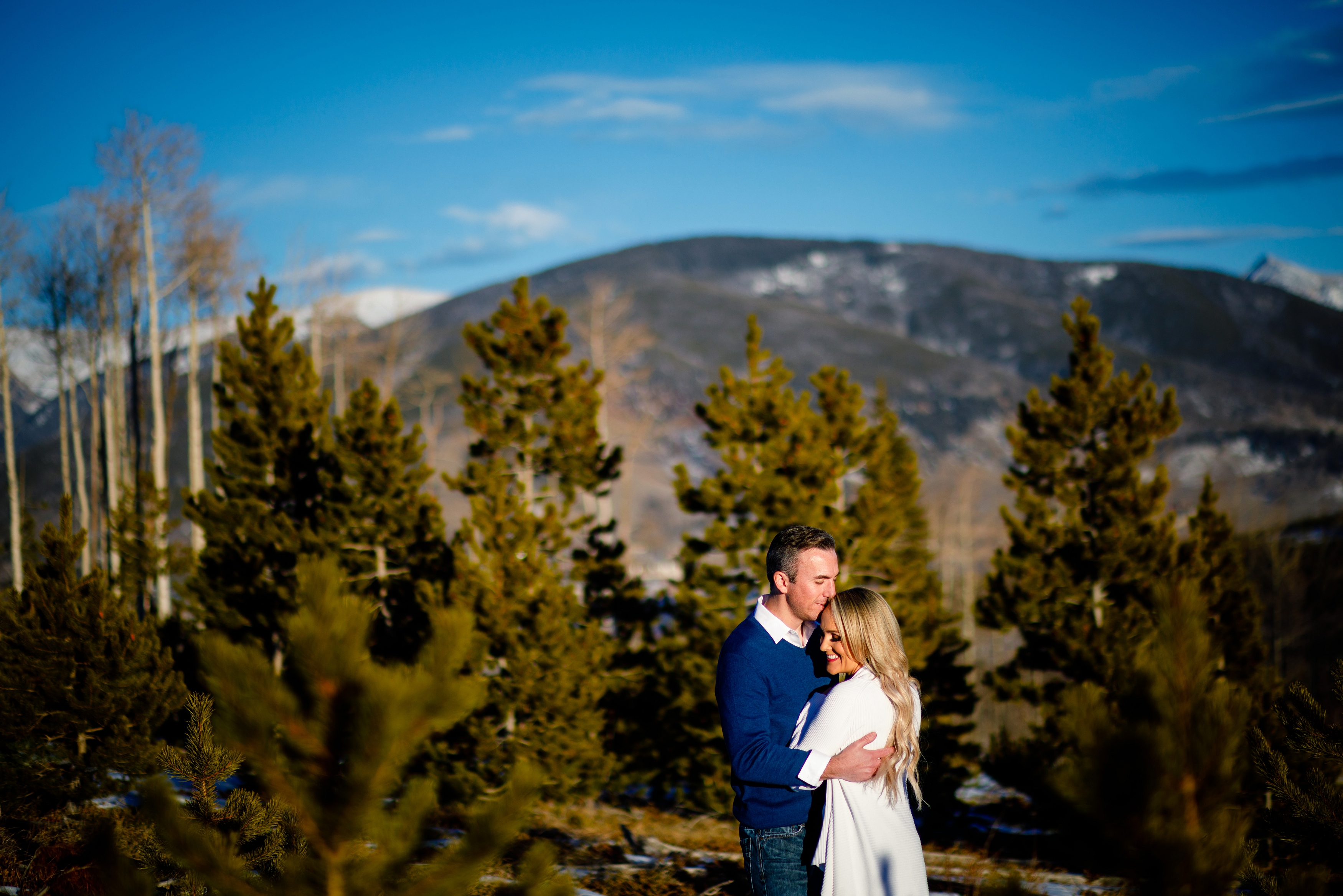 Beautiful couple posing in the warm sun during their engagement photo session in Silverthorne, CO.