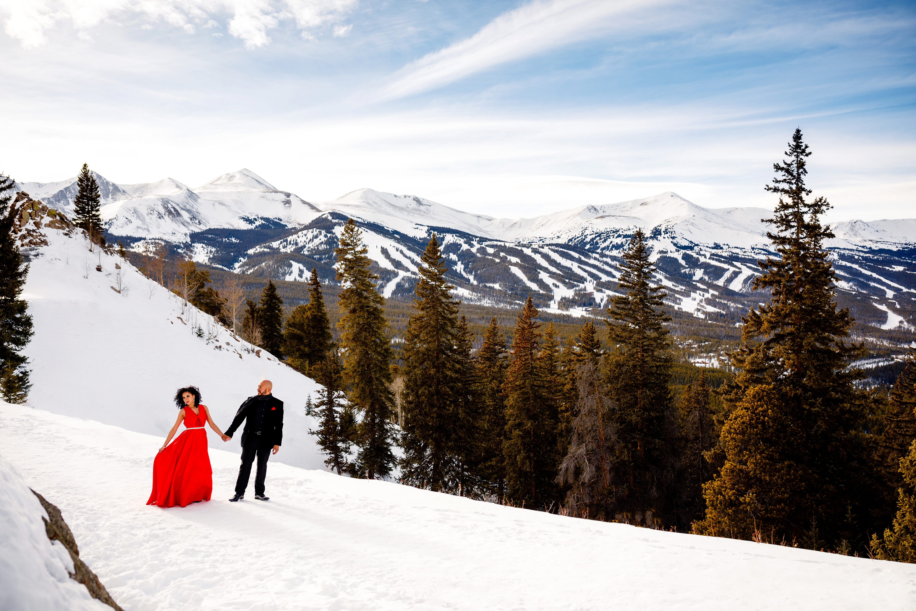 A beautiful couple strolls along Boreas Pass during their Winter Engagement session in Breckenridge.