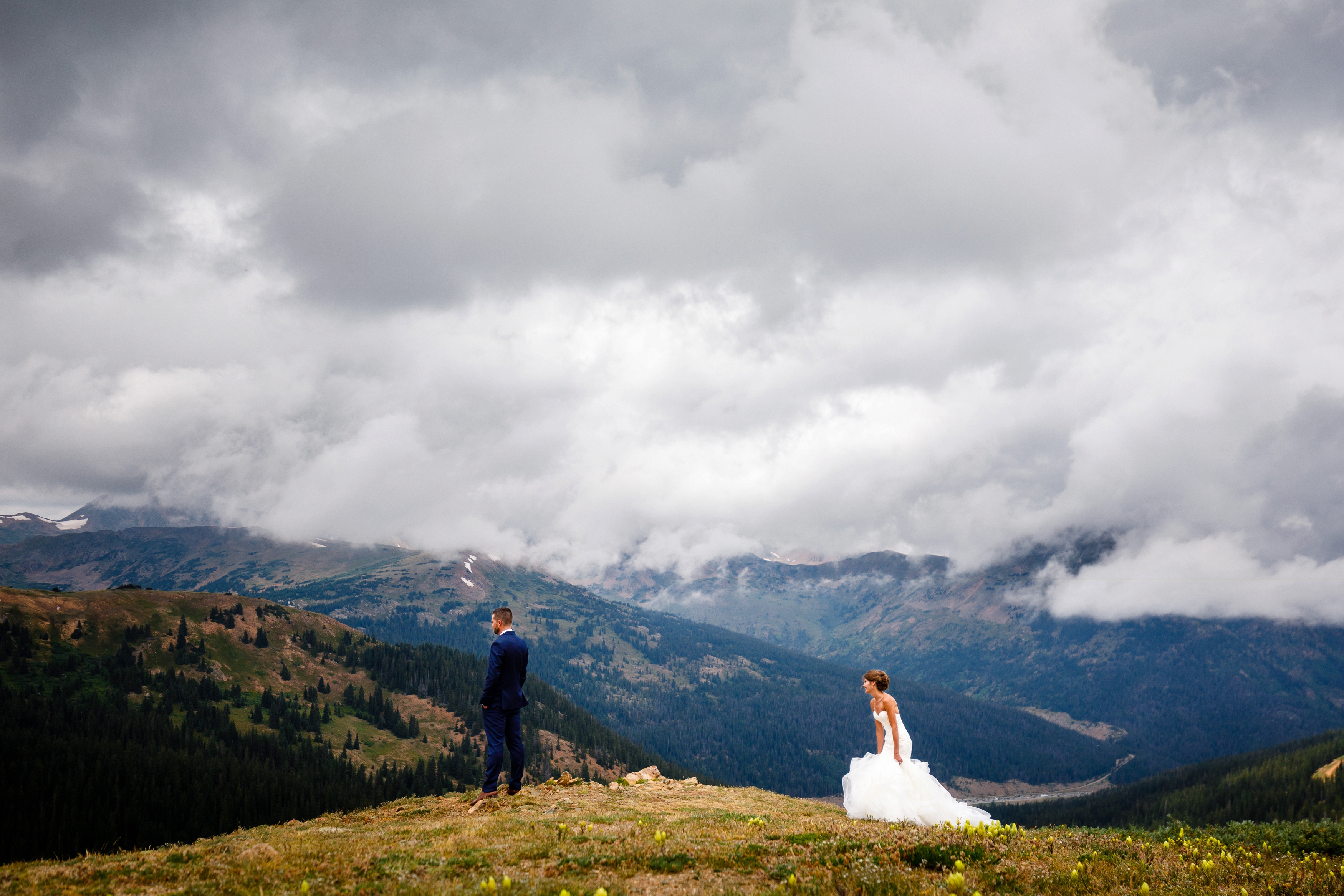 A bride and groom for their first look on top of Loveland Pass.