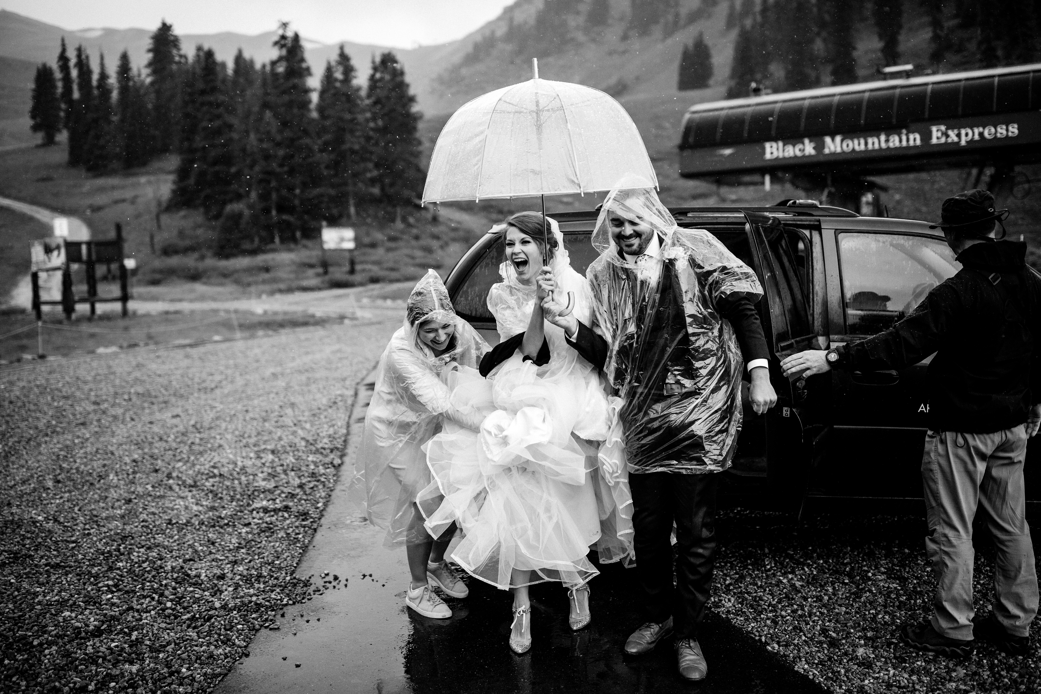 Bride gets out of vehicle at Black Mountain Lodge for her Arapahoe Basin Wedding.