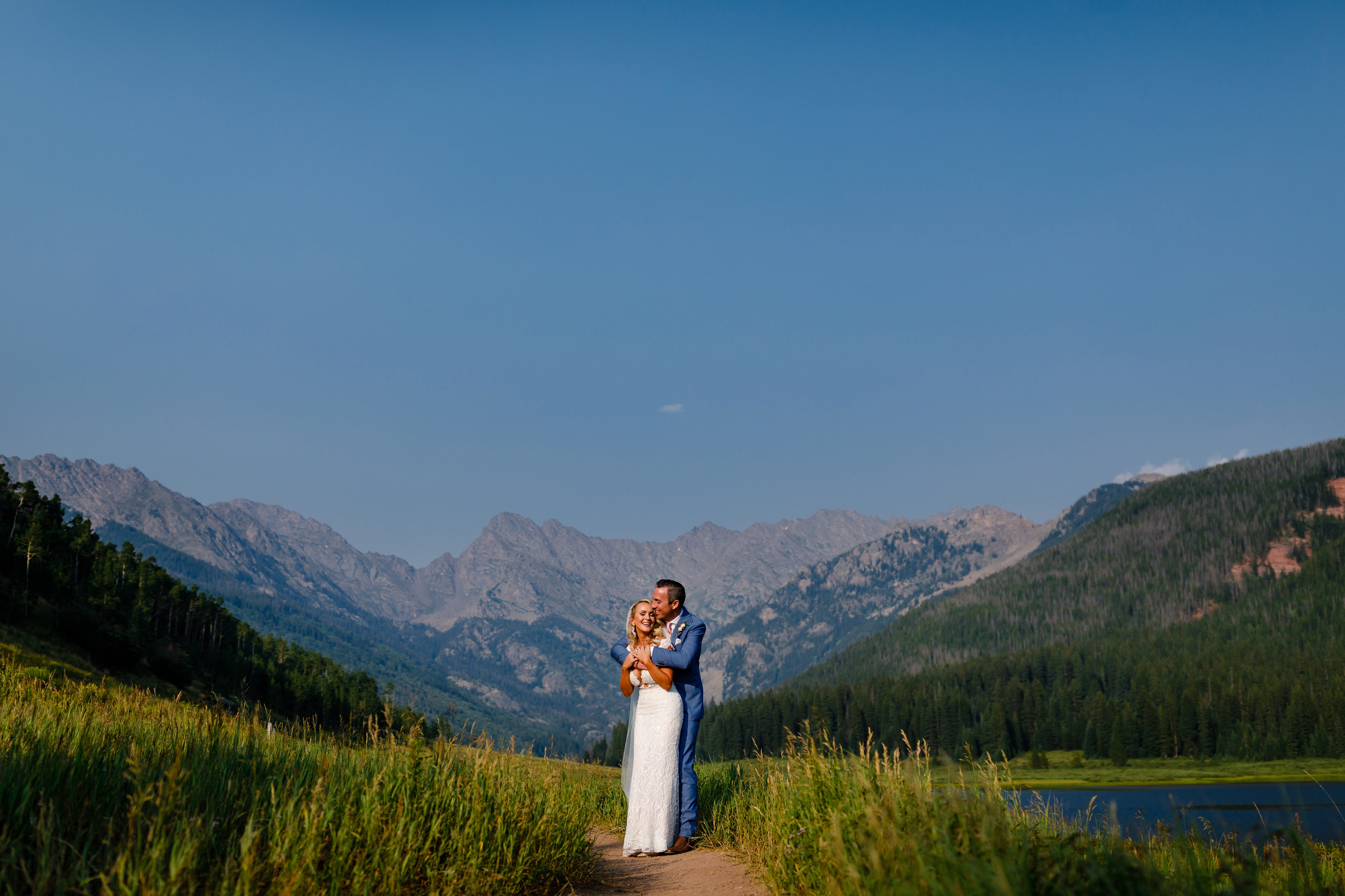 The bride & groom share a moment with the Gore Range in the background shortly after their Piney River Ranch Wedding Ceremony.