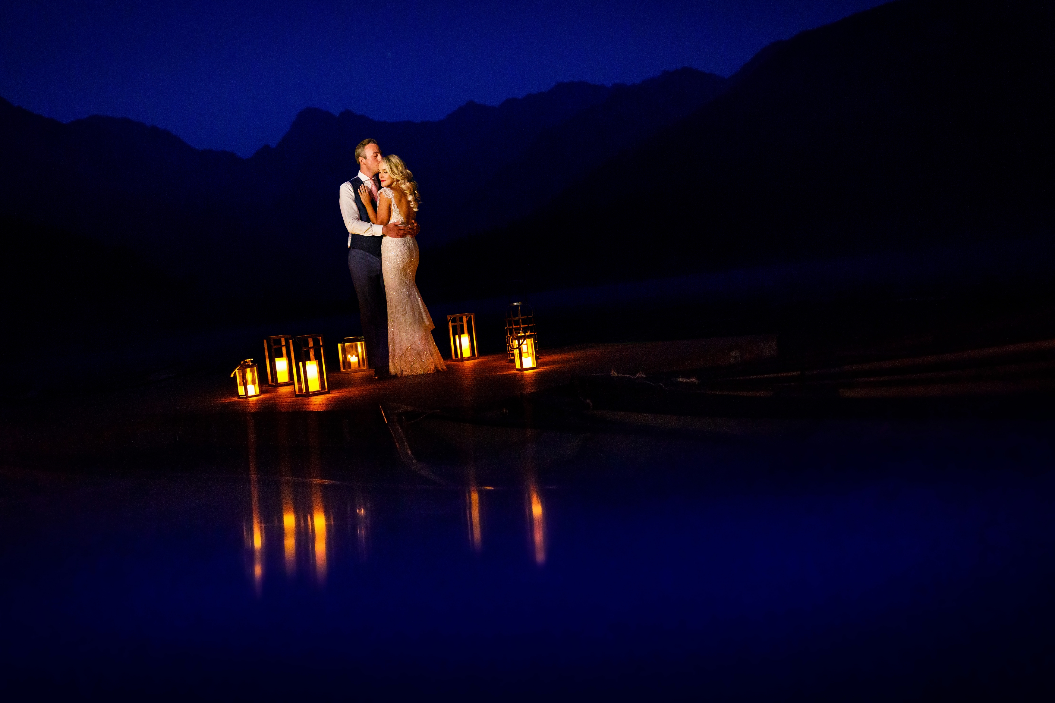 The bride & groom on the dock at Piney River Ranch for a portrait at dusk.