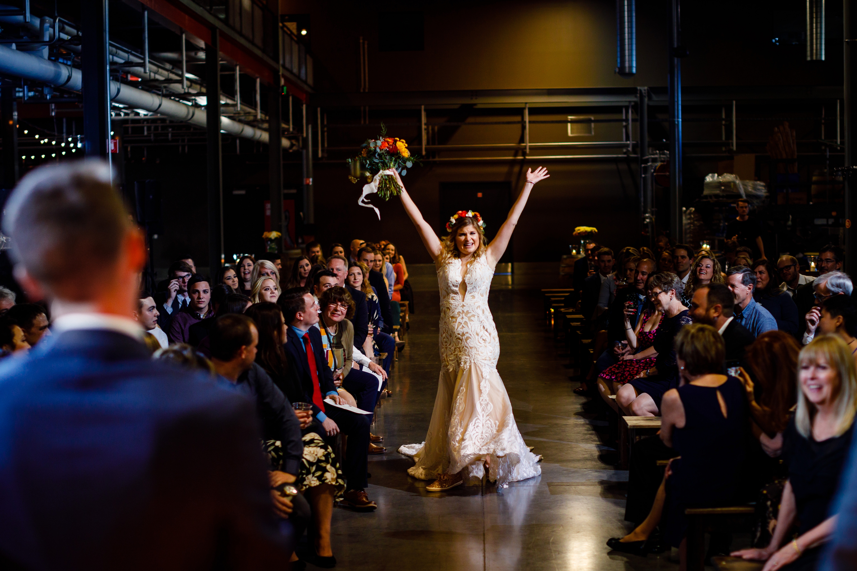 Jessica dancing down the isle before her & Jake's wedding ceremony at the Great Divide Barrel Bar.