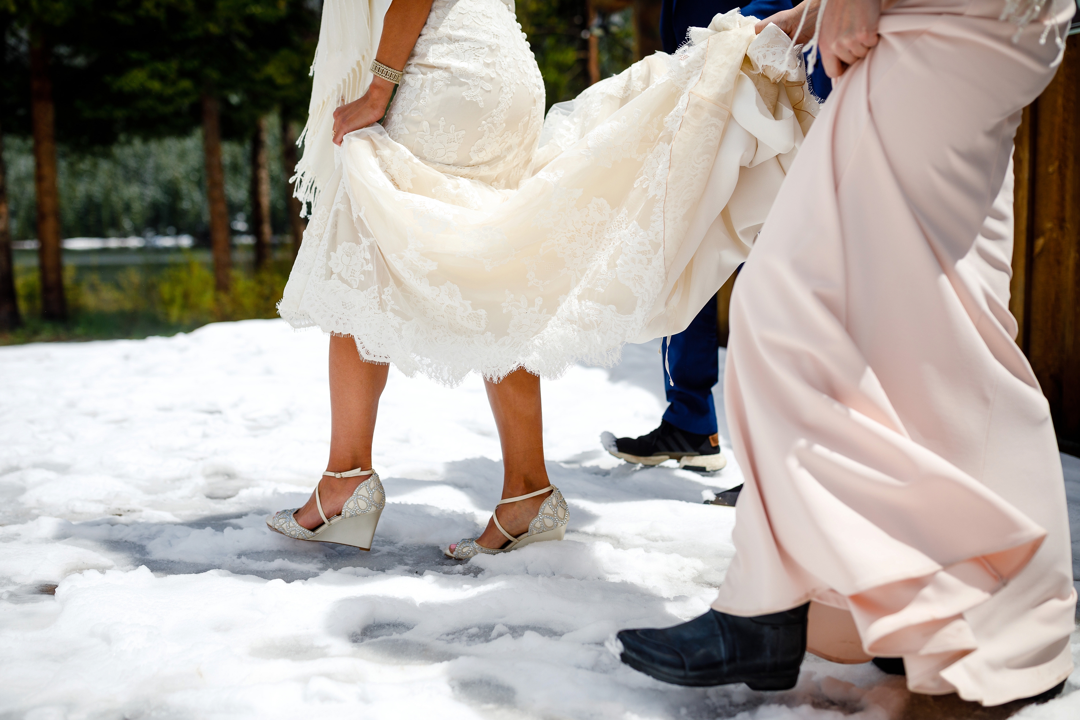 The bride walking through a few inches of snow as she heads to her first look at Piney.