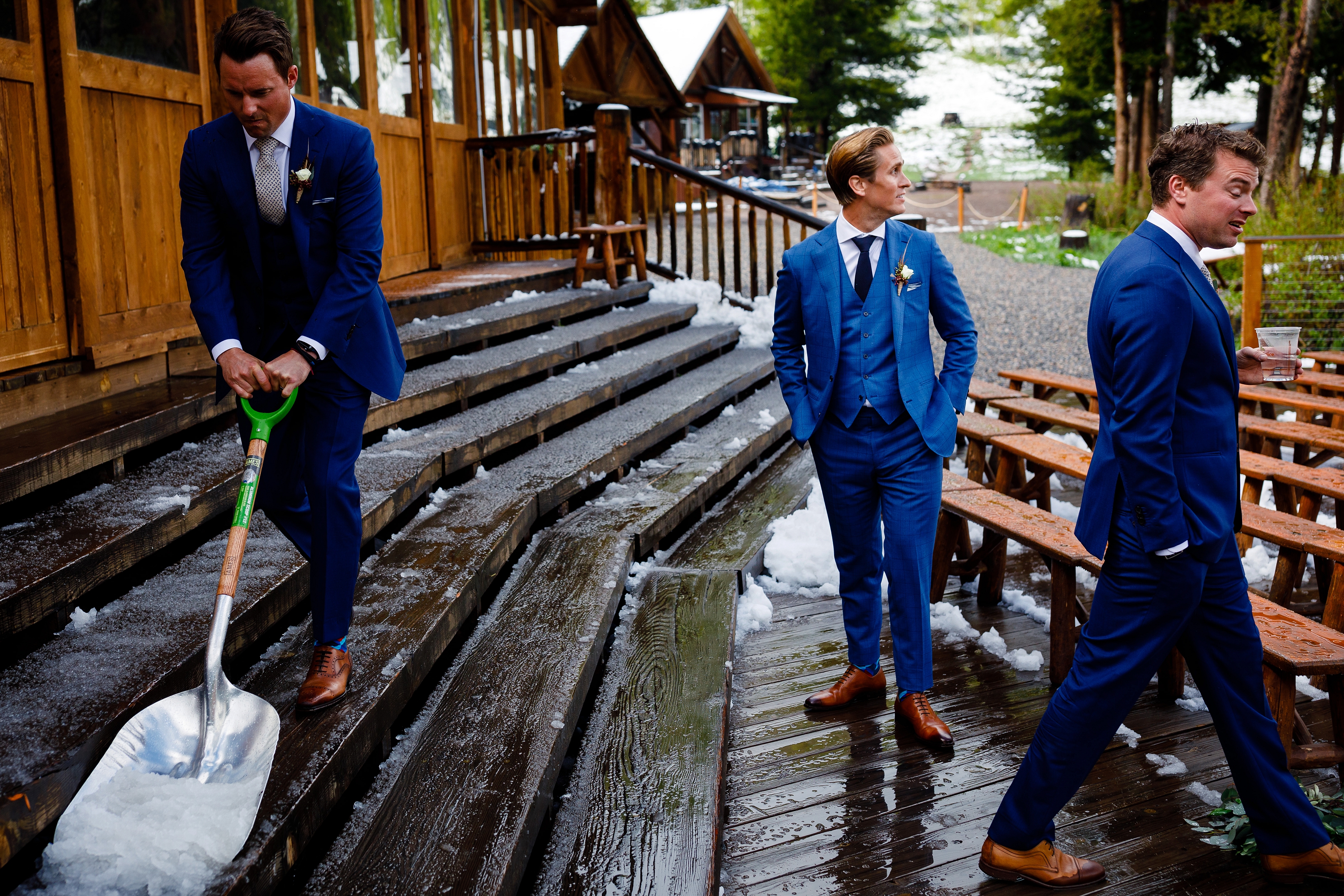 Whitney looks at the crazy snowstorm as his groomsmen shovel snow off the deck at Piney River Ranch.