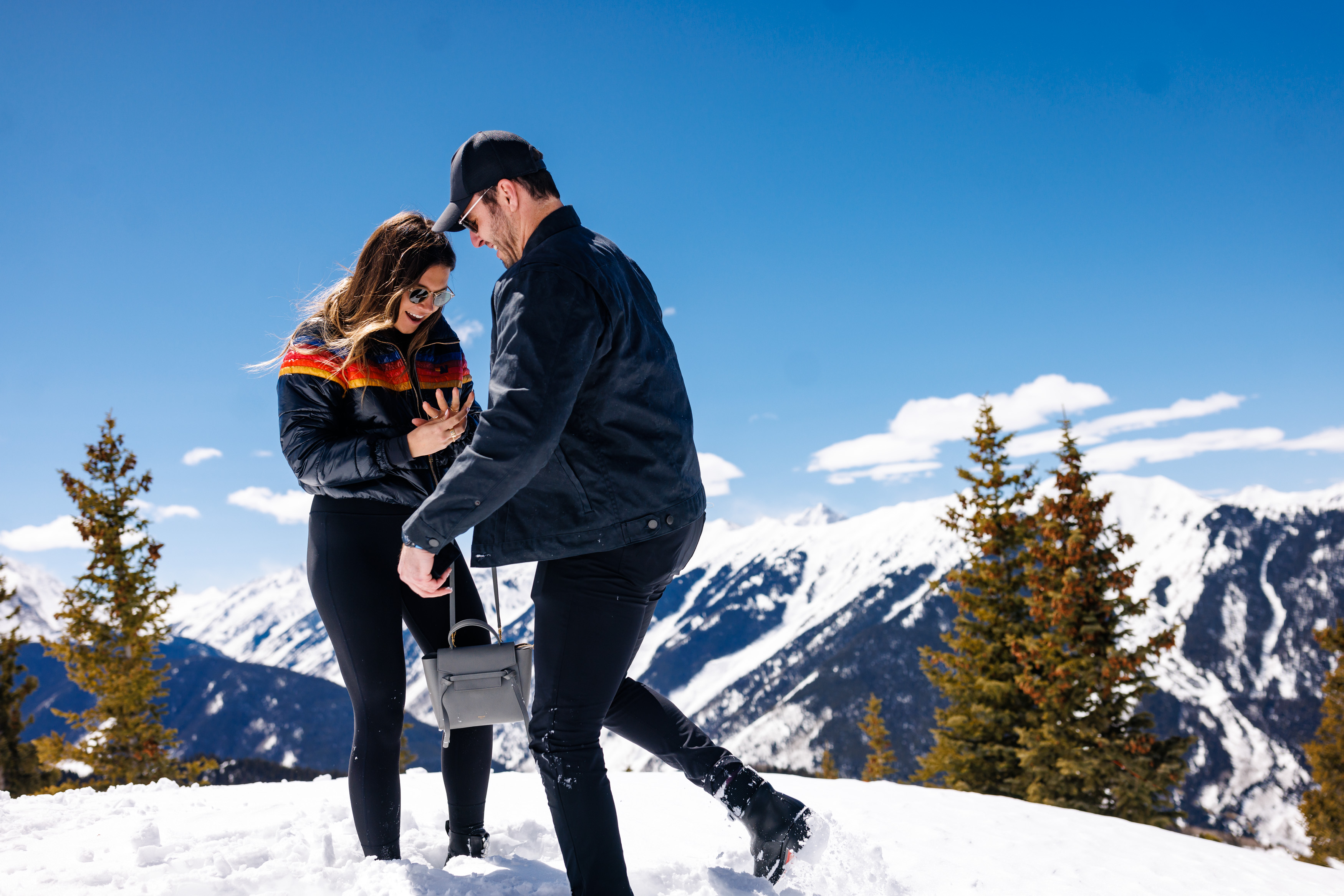 Zach and Molley, newly engaged, look down at the wedding ring shortly after their Proposal on Aspen Mountain.