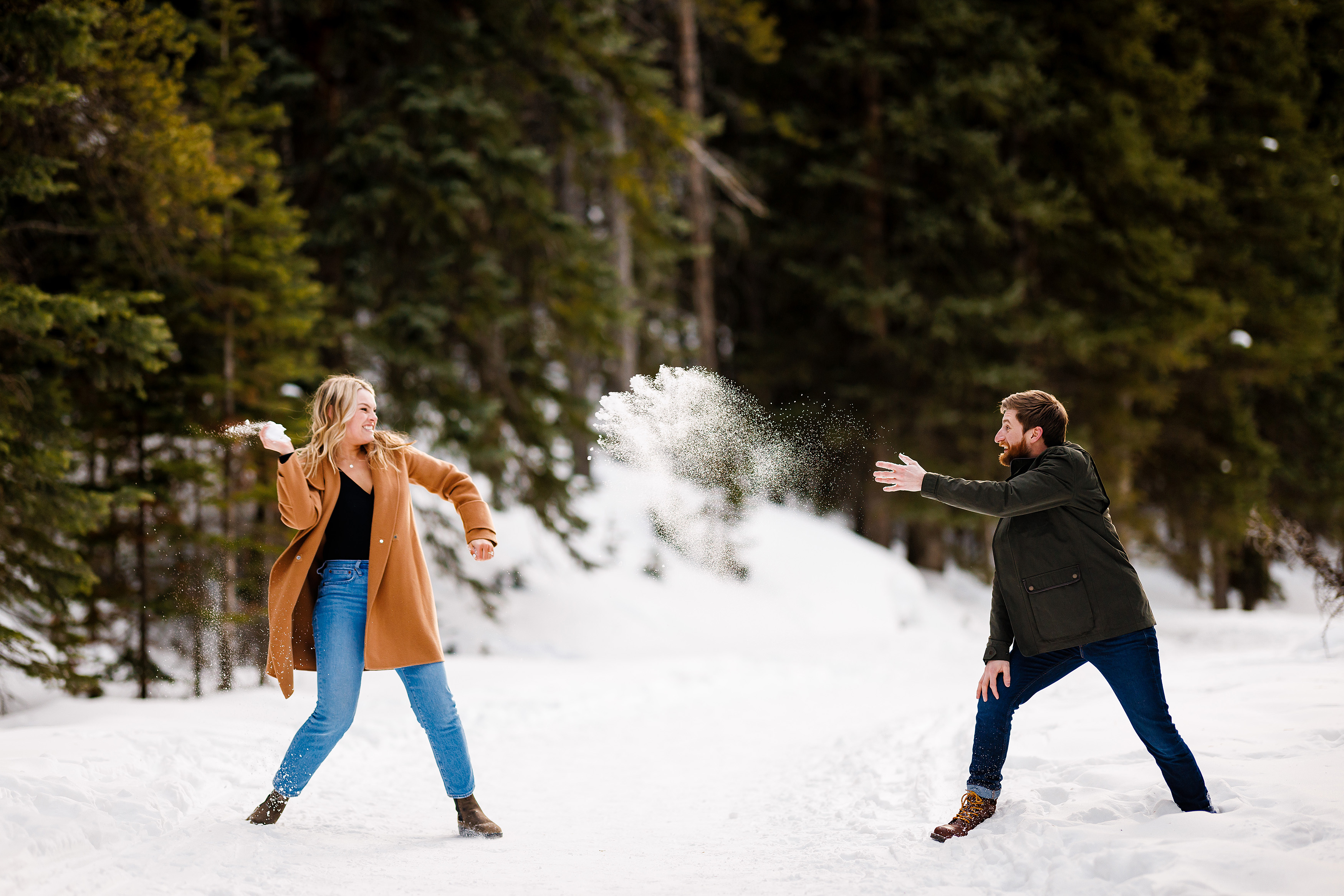 Zac & Audrey have a snowball fight with each other during their Breckenridge engagement photo session. 