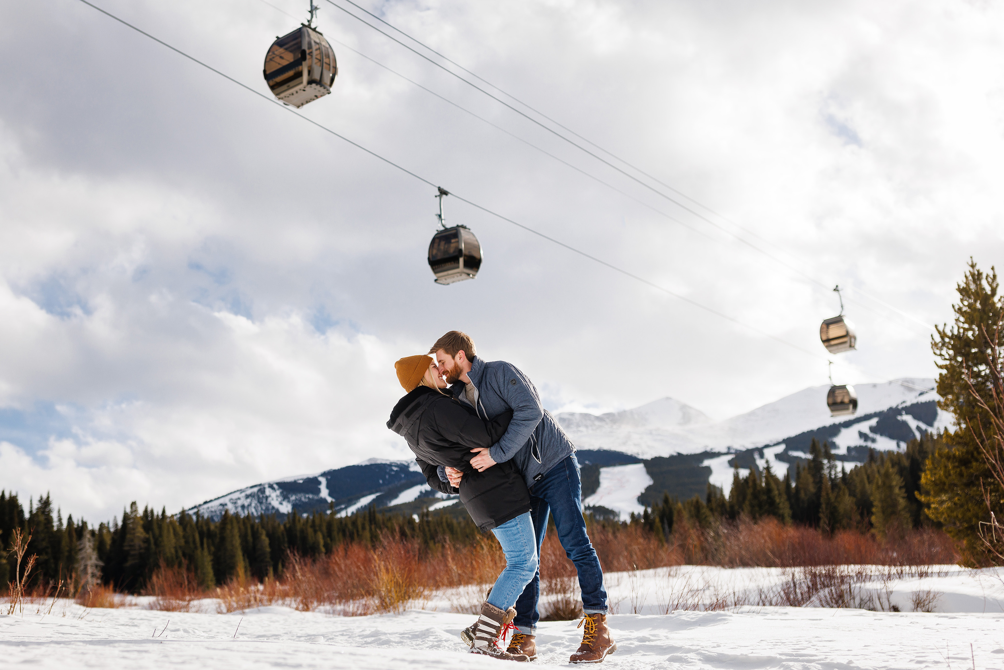 Zac and Audrey share a moment and a kiss underneath the Breckenridge Gondola shortly after their Breckenridge Nordic Center Proposal.
