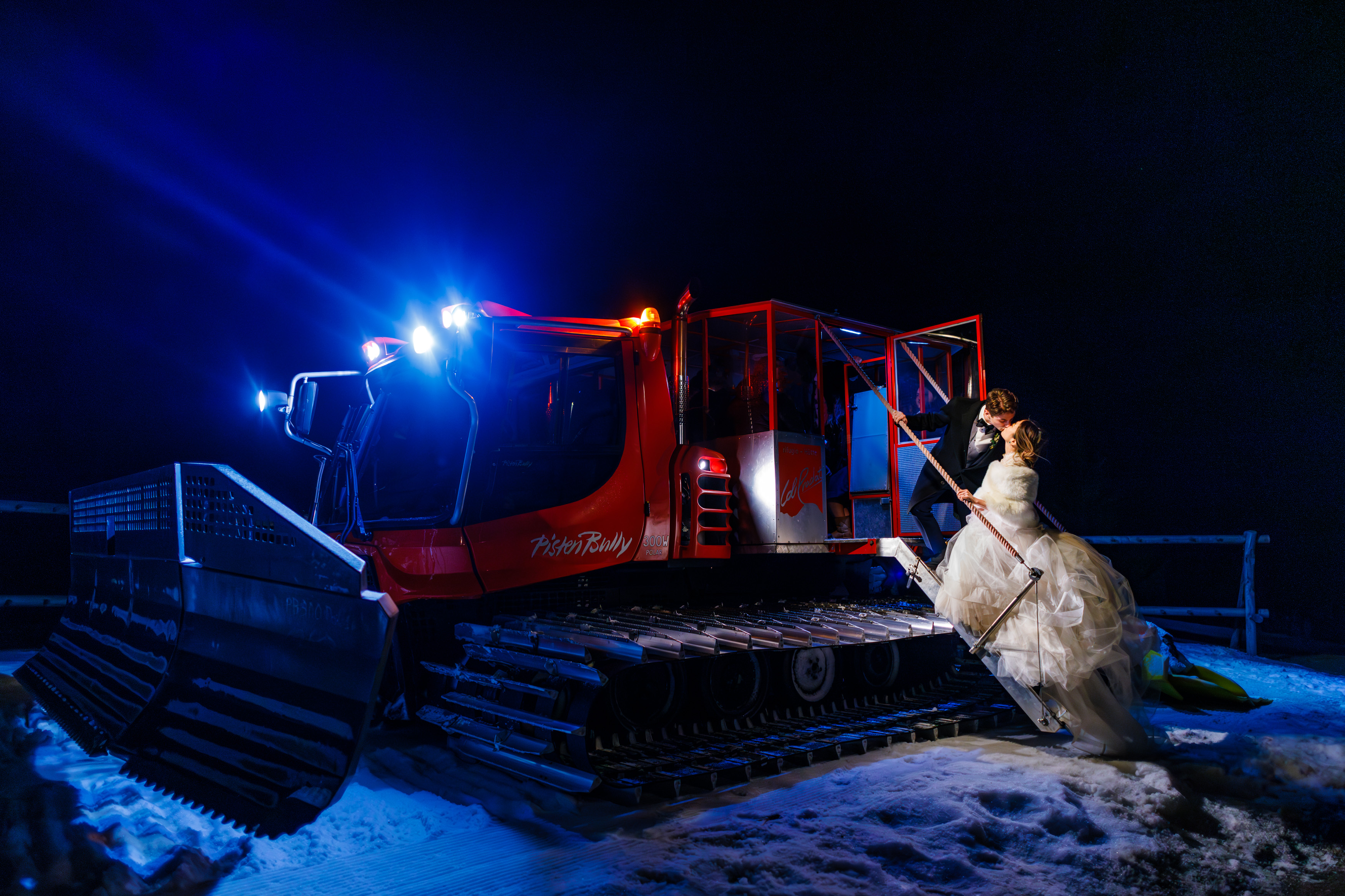 The newlywed couple hops in the snowcat for their ride back down the mountain following their beautiful Col Pradat Wedding.